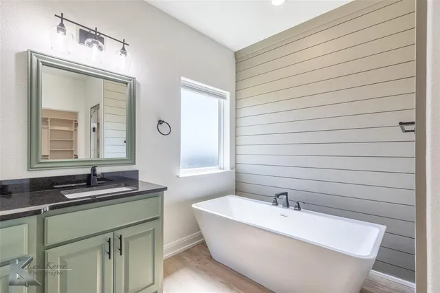 a bathroom with a bathtub and a sink