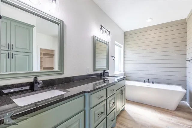 a bathroom with a double vanity sink and mirror