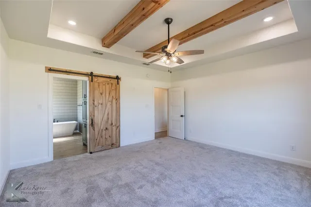 a view of a livingroom with a ceiling fan and entryway