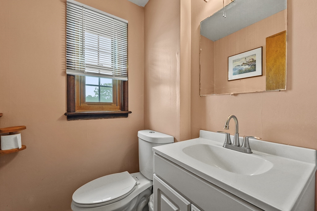 577 Grove Street Worcester, MA 01605 - Photo 11 of 39 a bathroom with a sink mirror and toilet
