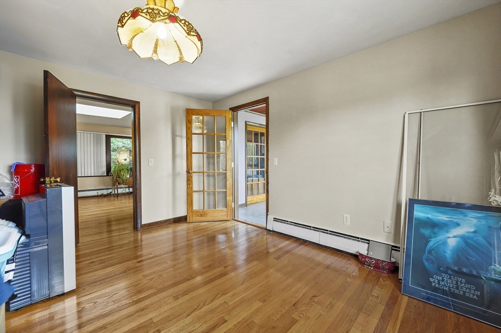 577 Grove Street Worcester, MA 01605 - Photo 13 of 39 wooden floor in an empty room with a window