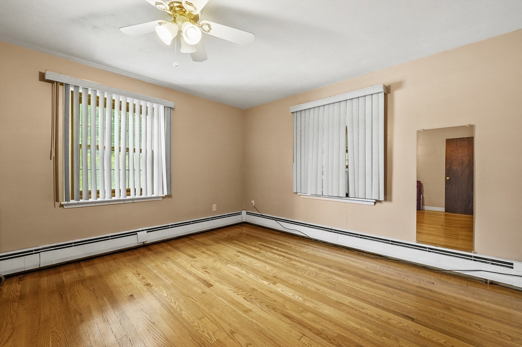 577 Grove Street Worcester, MA 01605 - Photo 18 of 39 a view of an empty room with wooden floor and a window