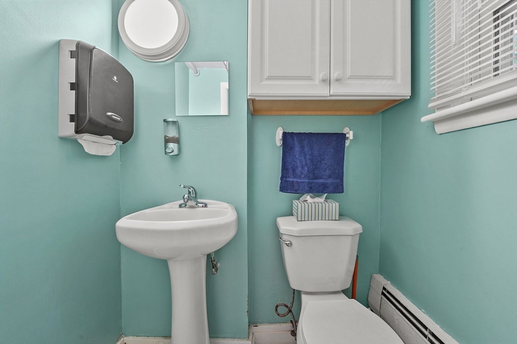 577 Grove Street Worcester, MA 01605 - Photo 22 of 39 a bathroom with a toilet sink and mirror