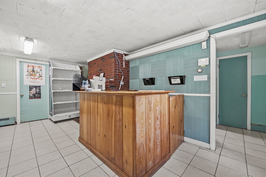 577 Grove Street Worcester, MA 01605 - Photo 23 of 39 a kitchen with stainless steel appliances granite countertop a refrigerator and a sink
