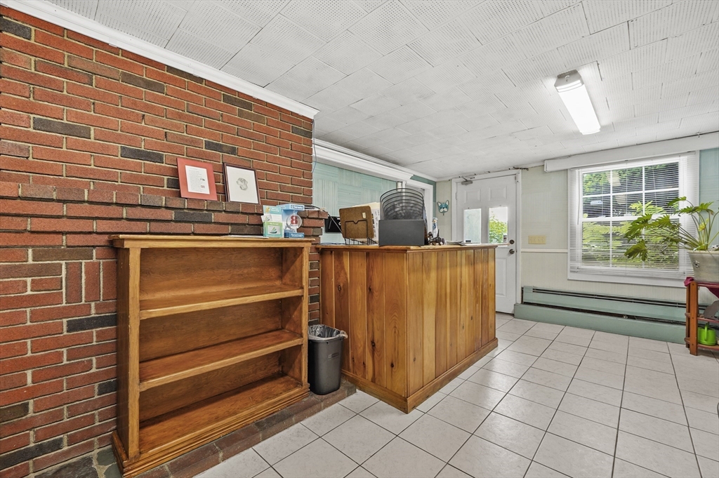 577 Grove Street Worcester, MA 01605 - Photo 24 of 39 a kitchen with stainless steel appliances kitchen island granite countertop a refrigerator and a stove