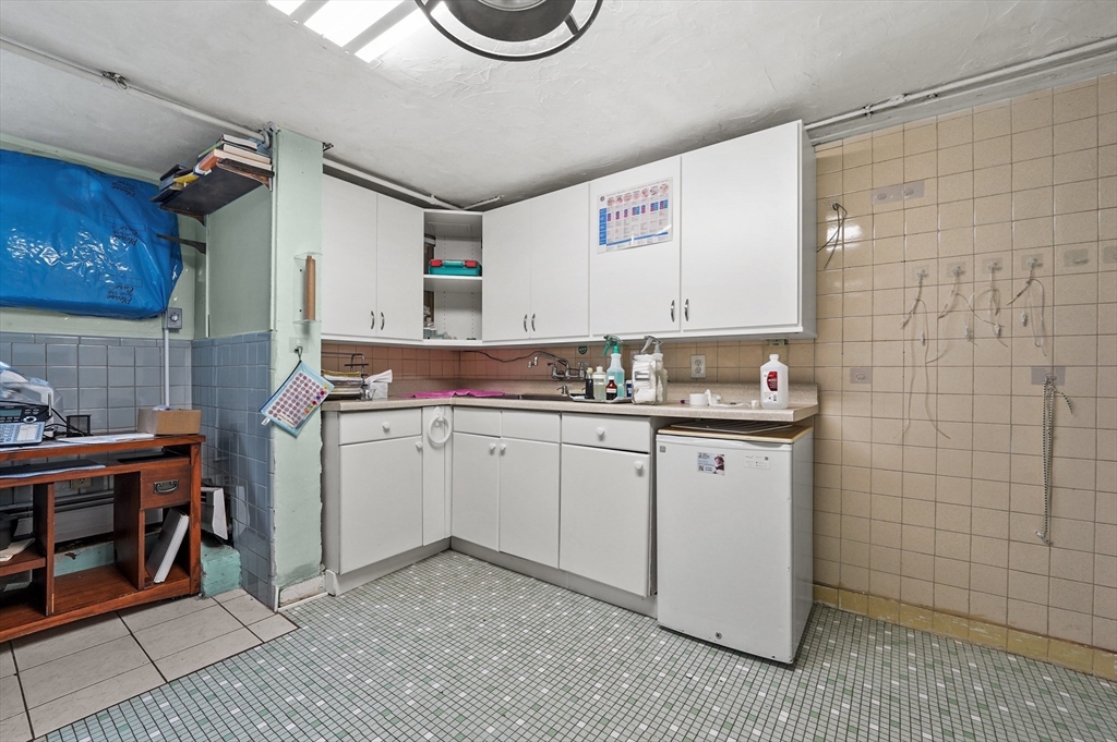 577 Grove Street Worcester, MA 01605 - Photo 26 of 39 a kitchen with a sink and cabinets