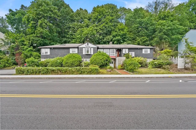 a front view of a house with a yard and a garage
