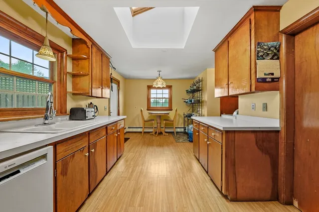 a kitchen with stainless steel appliances granite countertop a sink and a refrigerator