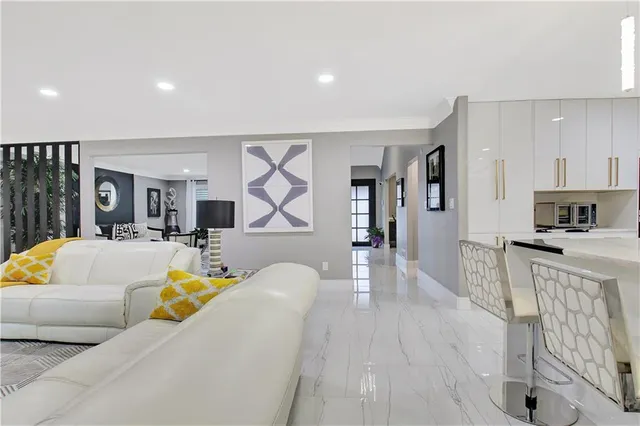 a living room with furniture and a painting on the wall