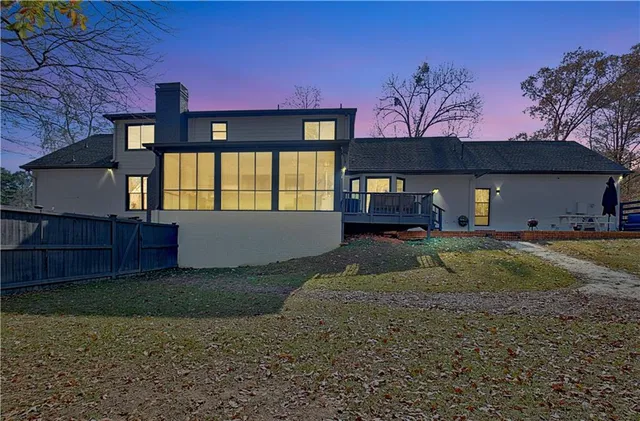 a view of a house with a yard covered in snow