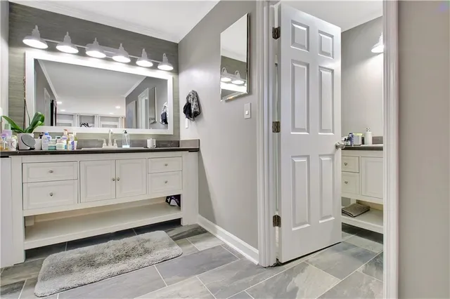 a bathroom with a sink vanity and toilet