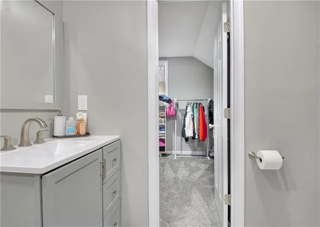 a view of walk in closet with clothes