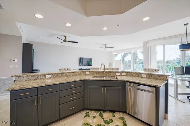 a kitchen with granite countertop sink stove and cabinets
