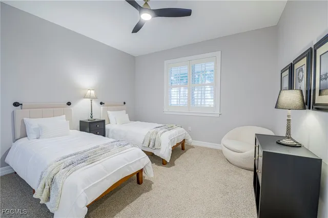 a bedroom with two beds and a lamp