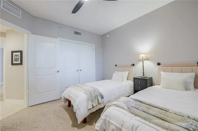 a bedroom with two beds and painted walls