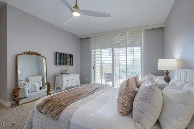 a bedroom with a large bed and a lamp