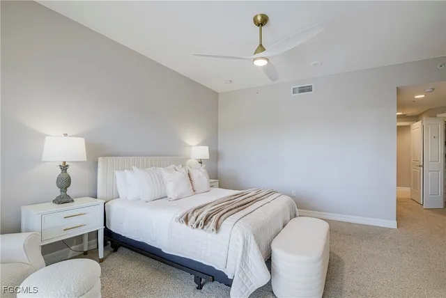 a bedroom with a bed and a lamp