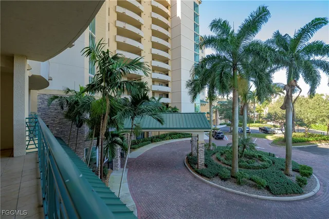 a view of a palm trees front of house and swimming pool