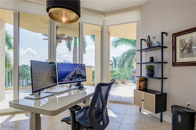 a view of a workspace with furniture and a flat screen tv