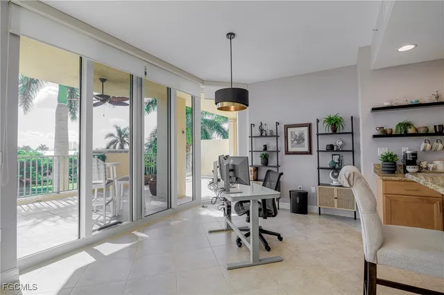 a workspace with furniture water view and a floor to ceiling window