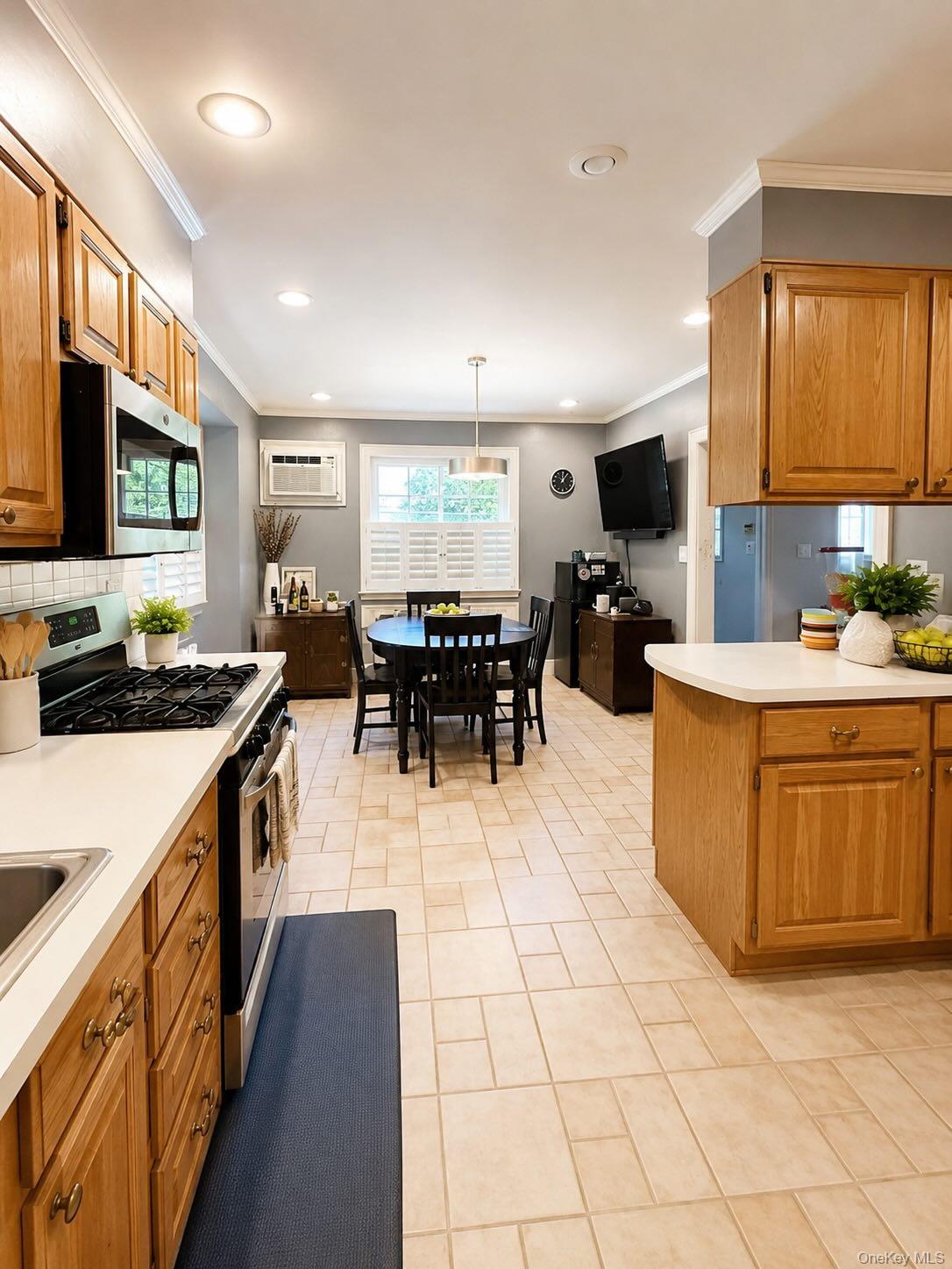 11 West Terrace Road Great Neck, NY 11021 - Photo 5 of 14 Open-concept kitchen and dining area featuring light wood cabinetry, light-toned tile flooring, and white countertops