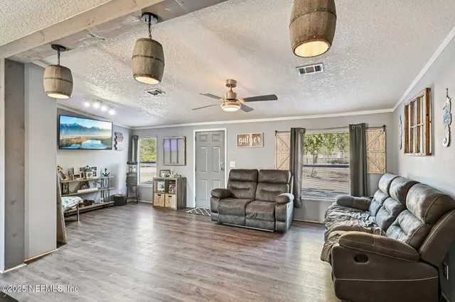a living room with furniture and kitchen view