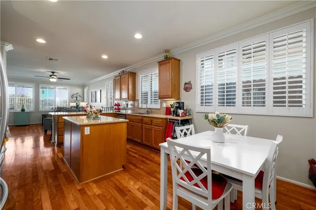 a kitchen with stainless steel appliances granite countertop a sink dishwasher and a fireplace with chair