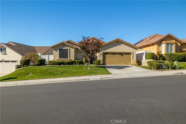 an aerial view of a house with a yard and lake view