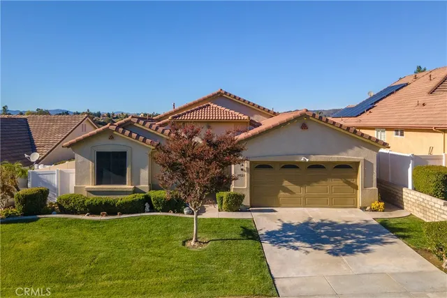 a dining room with furniture a rug and wooden floor