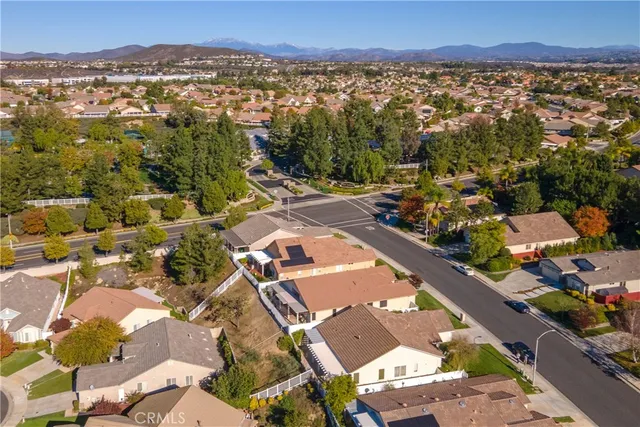 a view of a swimming pool with a yard and sitting area