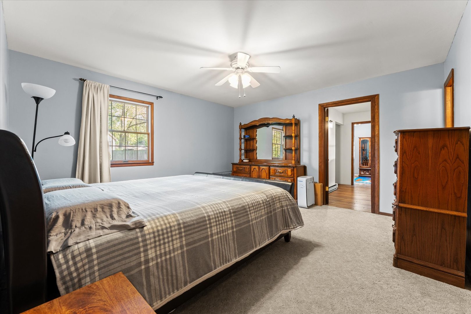 1108 Riverside Court Mahomet, IL 61853 - Photo 23 of 50 a bedroom with a large bed and a chandelier
