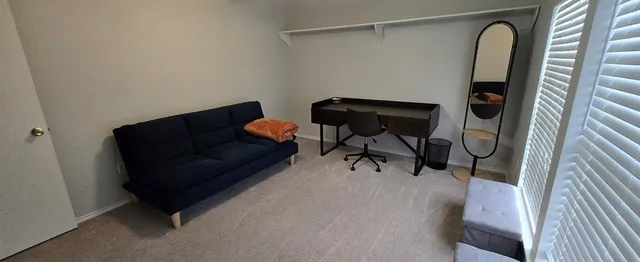 a living room with furniture and a mirror