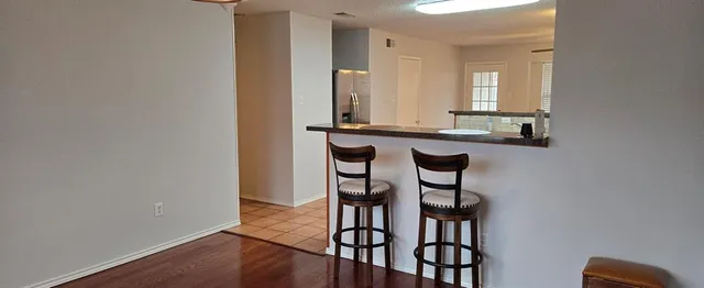 an entryway with a table and chairs
