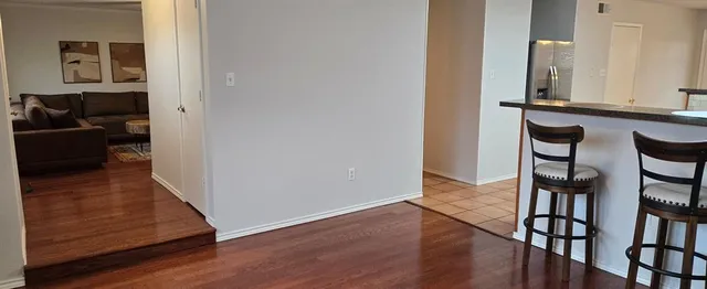 a view of a hallway with wooden floor and furniture