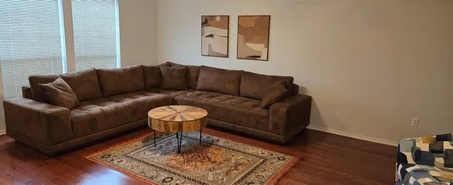 a living room with furniture and a rug