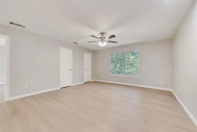 a view of an empty room with a fireplace