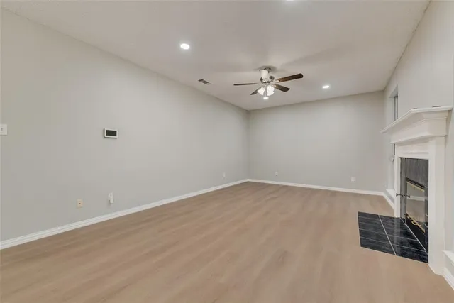 a view of an empty room with a fireplace