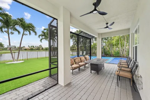 a living room with patio furniture and a yard