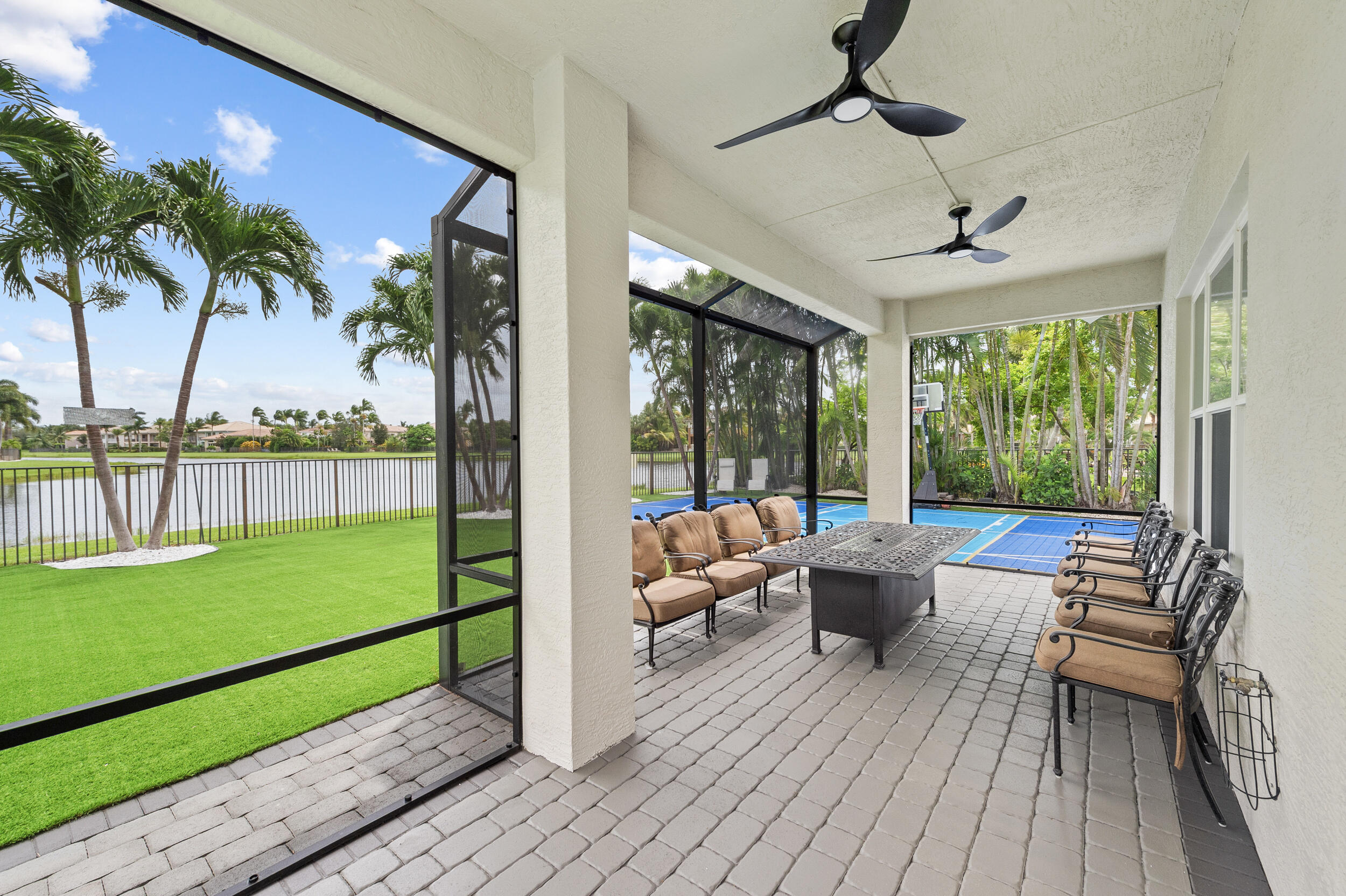 8680 Daystar Ridge Point Boynton Beach, FL 33473 - Photo 17 of 25 a living room with patio furniture and a yard
