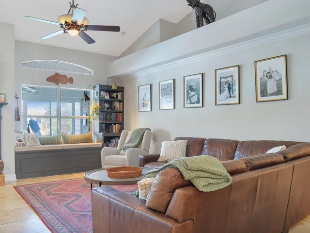 a living room with furniture and a book shelf