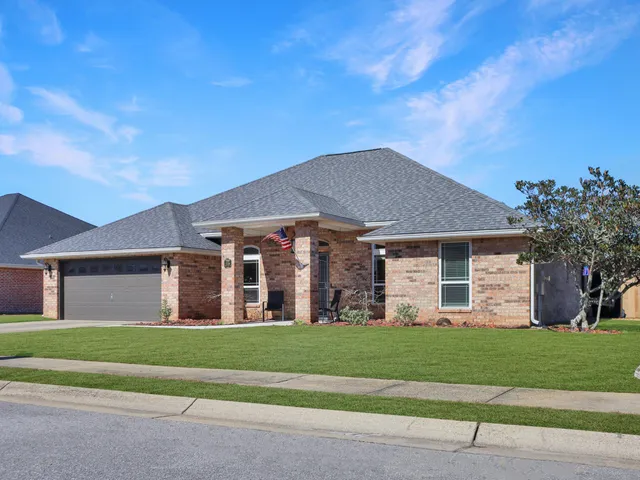 a kitchen with stainless steel appliances granite countertop a sink a stove and cabinets