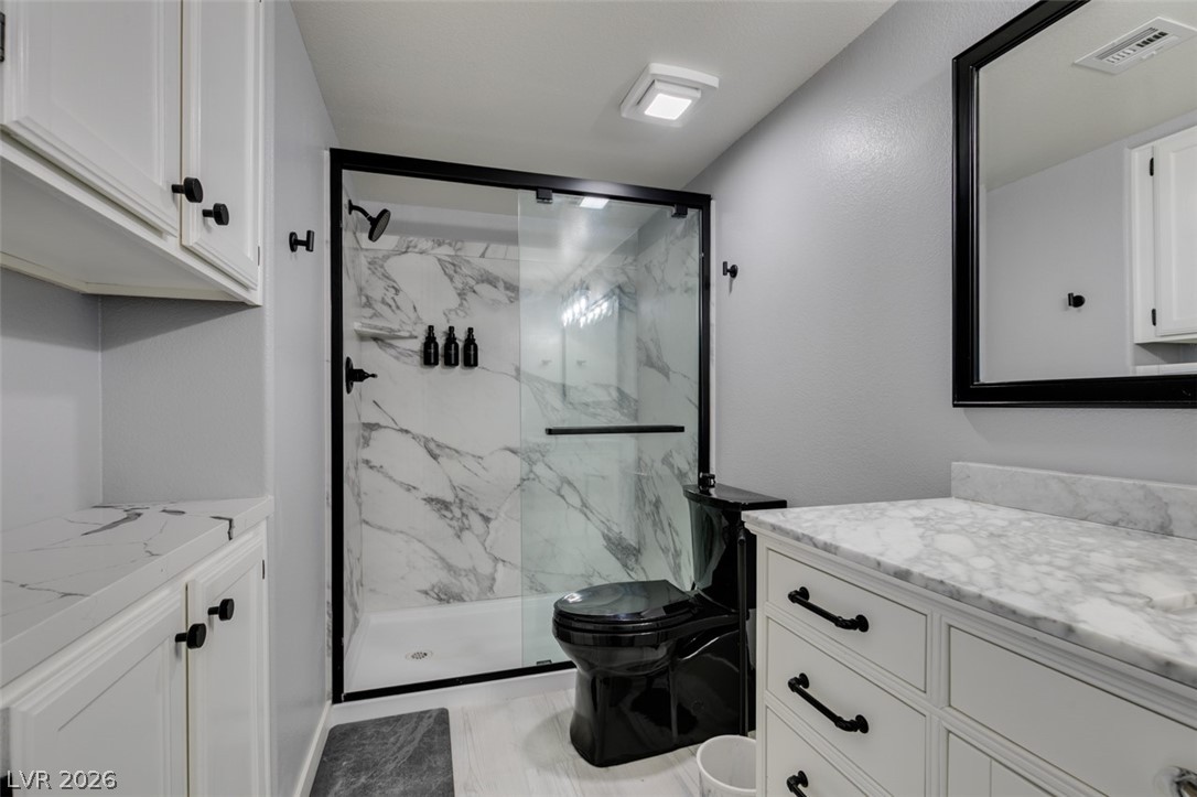 7255 West Sunset Road, Unit 1103 Las Vegas, NV 89113 - Photo 4 of 35 Marble accents and sleek fixtures define this contemporary bathroom.