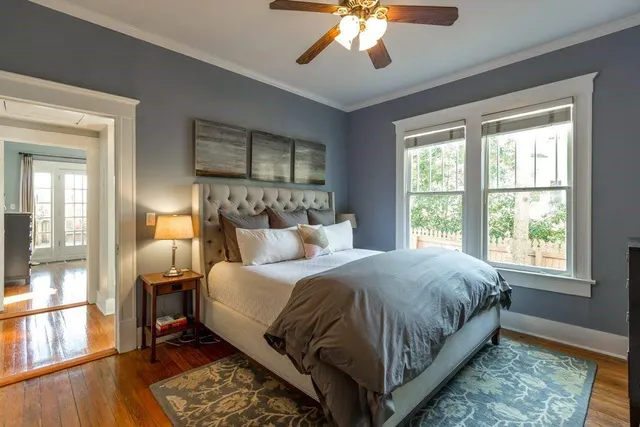 a bedroom with a large bed and a chandelier