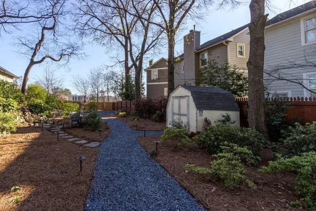 a view of a backyard with table and chairs and a fire pit