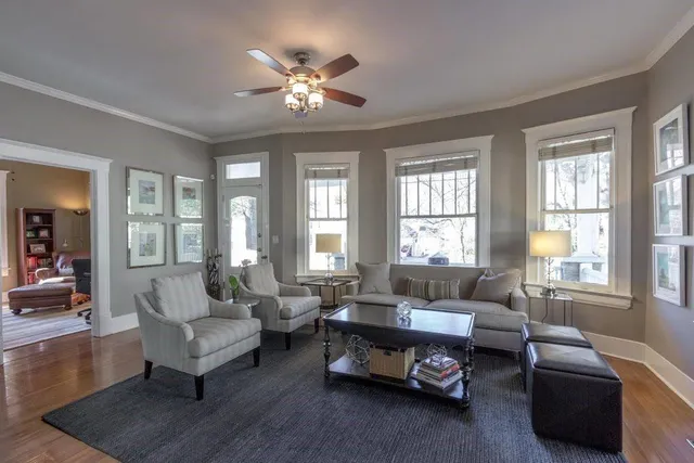a living room with furniture a flat screen tv and a fireplace
