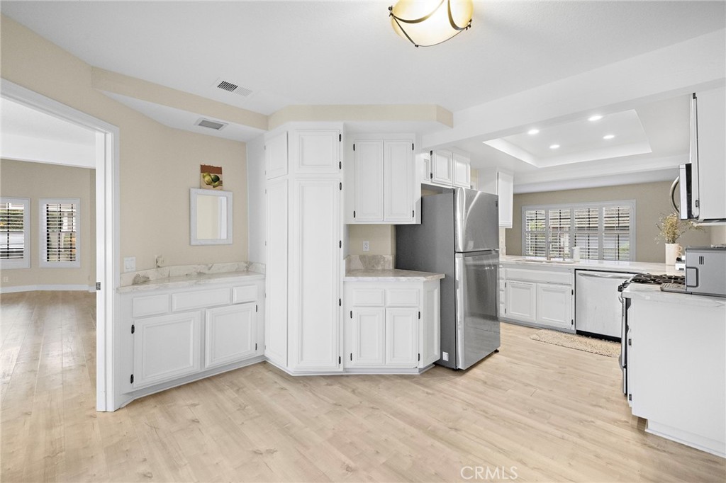 6 Fieldflower Irvine, CA 92614 - Photo 11 of 39 a kitchen with white cabinets and refrigerator