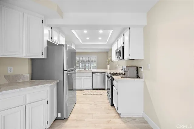 a kitchen with a white cabinets and white appliances