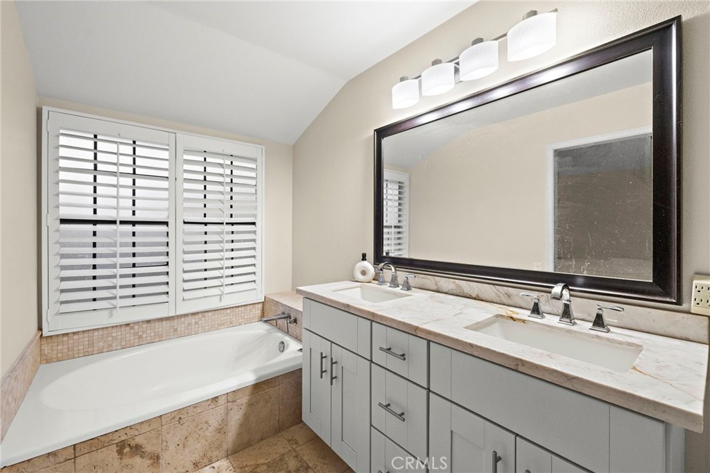 6 Fieldflower Irvine, CA 92614 - Photo 32 of 39 a bathroom with a granite countertop sink mirror and a bathtub