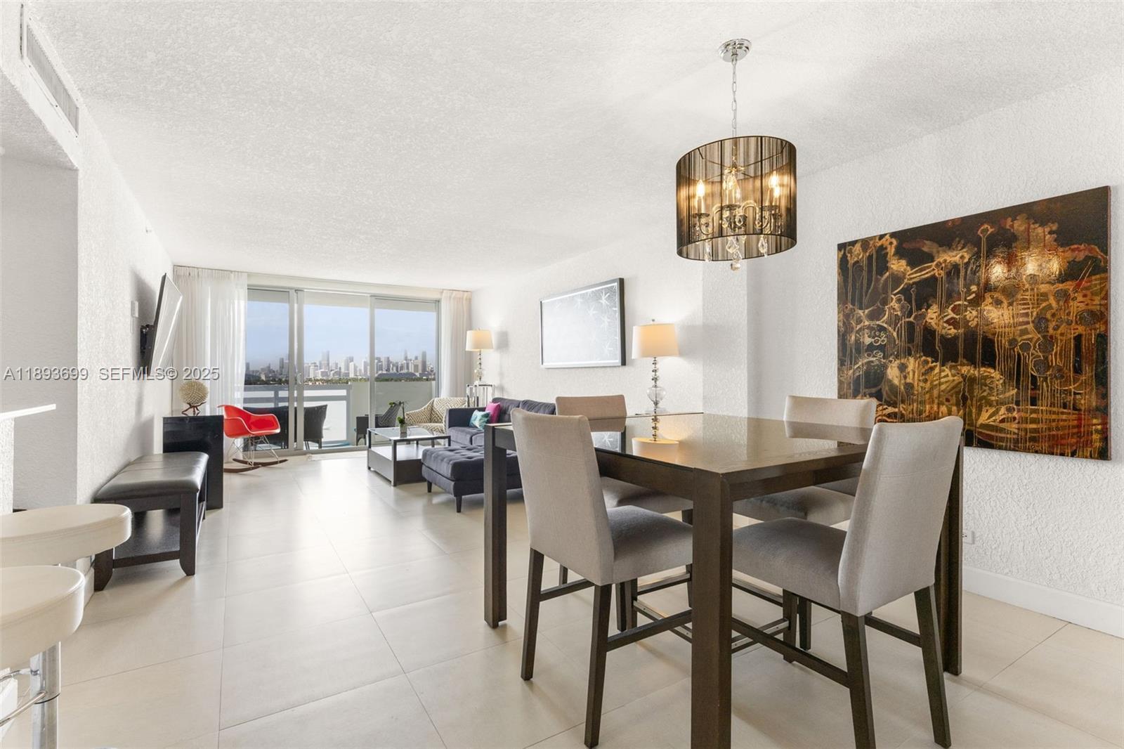 1500 Bay Road, Unit 1122S Miami Beach, FL 33139 - Photo 2 of 32 a view of a dining room with furniture and chandelier
