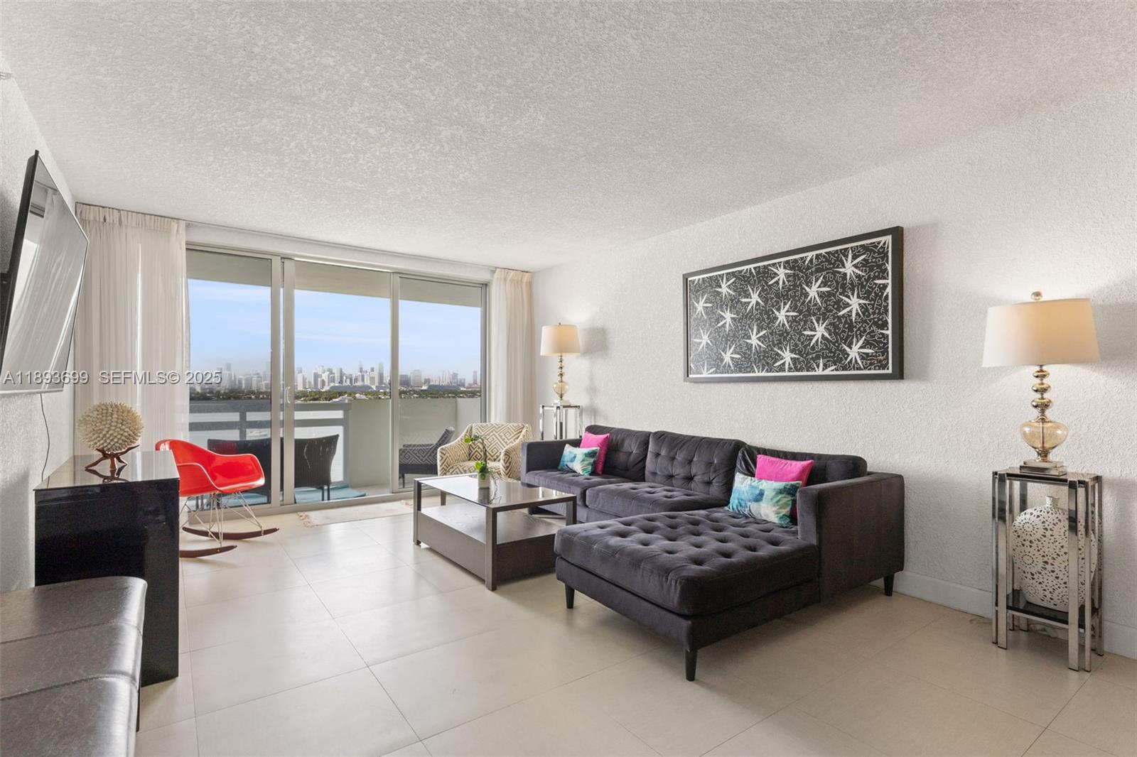 1500 Bay Road, Unit 1122S Miami Beach, FL 33139 - Photo 3 of 32 a living room with furniture and a large window
